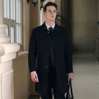 Male model wearing a sleek black men's overcoat with classic collar, button closure, and tailored fit, ideal for formal occasions.