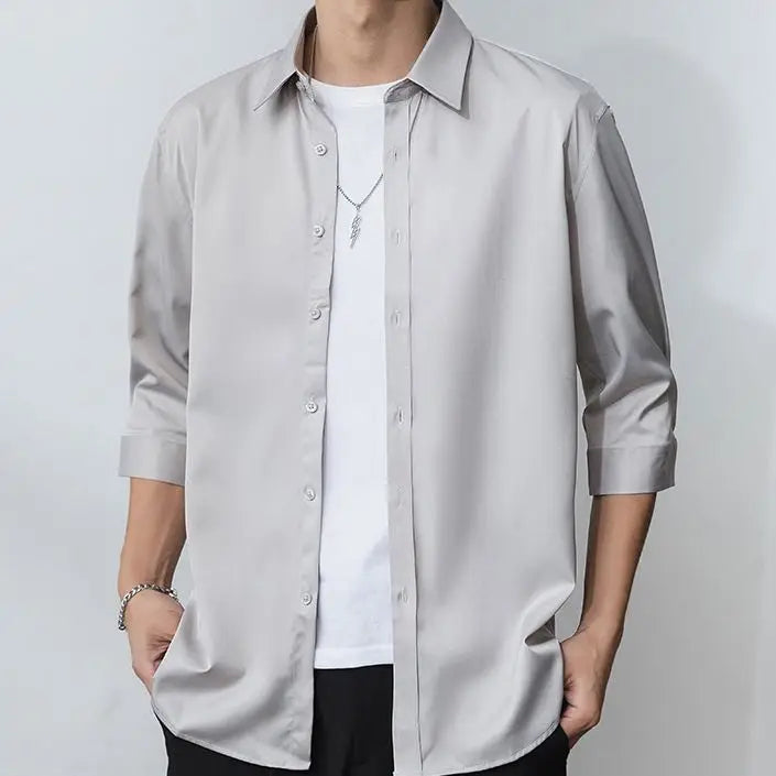 Julian's |Light gray button-up shirt worn by a person on a plain background